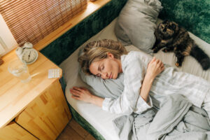 Carefree woman sleeping in bed early in the morning